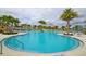 Resort-style pool with comfortable seating and palm trees at 2166 Fleming Mist Pl, Kissimmee, FL 34747