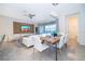 Dining area with wood table, white chairs, and adjacent living space at 2166 Fleming Mist Pl, Kissimmee, FL 34747
