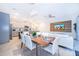 Open concept dining room and kitchen with modern appliances and light-colored cabinetry at 2166 Fleming Mist Pl, Kissimmee, FL 34747