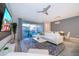 Open living room with white sectional sofa, large TV, and view of backyard at 2166 Fleming Mist Pl, Kissimmee, FL 34747
