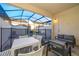 Covered patio with seating area, dining table, and view of private pool at 2166 Fleming Mist Pl, Kissimmee, FL 34747