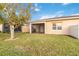 Backyard view of house with screened patio and large tree at 2482 Yellow Brick Rd, St Cloud, FL 34772