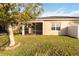 Backyard view of house with screened patio and large tree at 2482 Yellow Brick Rd, Saint Cloud, FL 34772