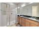 Bathroom boasts double sinks, granite countertop, and a walk-in shower at 2482 Yellow Brick Rd, St Cloud, FL 34772