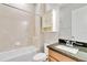 Bathroom with tub, granite vanity, and white cabinets at 2482 Yellow Brick Rd, St Cloud, FL 34772