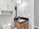 Small bathroom with granite vanity and white cabinets at 2482 Yellow Brick Rd, St Cloud, FL 34772