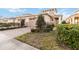 Two-story home with tan exterior, two-car garage, and landscaped yard at 2482 Yellow Brick Rd, St Cloud, FL 34772