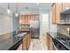 Modern kitchen with island, stainless steel appliances, and granite countertops at 2482 Yellow Brick Rd, St Cloud, FL 34772