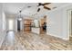 Open kitchen with island, stainless steel appliances, and light wood cabinets at 2482 Yellow Brick Rd, St Cloud, FL 34772