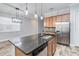 Modern kitchen with island, stainless steel appliances, and granite countertops at 2482 Yellow Brick Rd, St Cloud, FL 34772