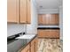 Laundry room features wood cabinets and granite countertops at 2482 Yellow Brick Rd, St Cloud, FL 34772