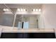 Double vanity bathroom with a large mirror and updated light fixtures at 254 Bella Prestwick Blvd, Davenport, FL 33837