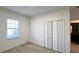 Bright bedroom with window, closet, and carpet at 254 Bella Prestwick Blvd, Davenport, FL 33837