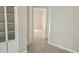 Clean hallway with tile flooring and built-in shelving at 2602 Lemon Tree Ln # H, Orlando, FL 32839