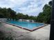 Community swimming pool with lounge chairs at 2602 Lemon Tree Ln # H, Orlando, FL 32839