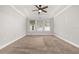 Large bedroom with neutral walls, ceiling fan and wall-to-wall carpet at 3006 Princewood Dr, Minneola, FL 34715