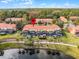Community view showcasing townhomes, pools, and a lake at 3083 Yellow Lantana Ln, Kissimmee, FL 34747