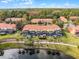 Community view showcasing townhomes, pools, and a lake at 3083 Yellow Lantana Ln, Kissimmee, FL 34747