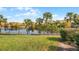 Backyard with a view of a lake and a manicured lawn at 3083 Yellow Lantana Ln, Kissimmee, FL 34747