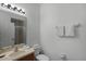 Clean bathroom with a single sink vanity, toilet and shower at 3083 Yellow Lantana Ln, Kissimmee, FL 34747