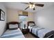 Twin bedroom with two beds and nightstand at 3083 Yellow Lantana Ln, Kissimmee, FL 34747