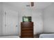 Bedroom with dresser, TV, and two doors at 3083 Yellow Lantana Ln, Kissimmee, FL 34747