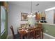 Bright dining room features a wood table and chairs, ready for Gathering meals at 3083 Yellow Lantana Ln, Kissimmee, FL 34747