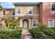 Townhouse exterior, featuring a two-story design and landscaping at 3083 Yellow Lantana Ln, Kissimmee, FL 34747