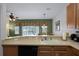 Kitchen with breakfast bar overlooking living room at 3083 Yellow Lantana Ln, Kissimmee, FL 34747