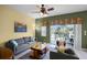 Living room with patio doors leading to pool area at 3083 Yellow Lantana Ln, Kissimmee, FL 34747