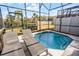 Relaxing screened-in pool and spa with lounge chairs at 3083 Yellow Lantana Ln, Kissimmee, FL 34747