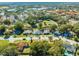 Aerial view of a home with solar panels and a neighborhood at 309 Poinciana Cir, Kissimmee, FL 34744
