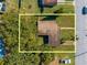 Aerial view of a home's roof and surrounding yard at 309 Poinciana Cir, Kissimmee, FL 34744