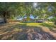 Large backyard with tree and playset at 309 Poinciana Cir, Kissimmee, FL 34744