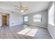 Spacious bedroom with gray walls, wood-look flooring, and ceiling fan at 309 Poinciana Cir, Kissimmee, FL 34744