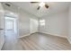 Spacious bedroom with gray walls, wood-look flooring, and ceiling fan at 309 Poinciana Cir, Kissimmee, FL 34744
