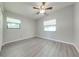Bright bedroom with gray walls, wood-look floors, and ceiling fan at 309 Poinciana Cir, Kissimmee, FL 34744