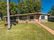 Mid-century modern home with a coral door at 309 Poinciana Cir, Kissimmee, FL 34744