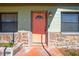 Coral front door with stonework at 309 Poinciana Cir, Kissimmee, FL 34744
