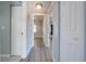 Clean hallway with light gray walls and wood-look flooring at 309 Poinciana Cir, Kissimmee, FL 34744