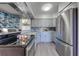 Modern gray kitchen with stainless steel appliances at 309 Poinciana Cir, Kissimmee, FL 34744