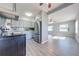 Remodeled kitchen features gray cabinets, stainless steel appliances, and blue tile backsplash at 309 Poinciana Cir, Kissimmee, FL 34744