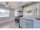 Modern kitchen with stainless steel appliances and gray cabinets at 309 Poinciana Cir, Kissimmee, FL 34744