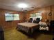 Main bedroom with wood-paneled walls, a king-size bed, and ample space at 3800 Lavender Way, Casselberry, FL 32707