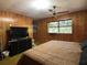 Spacious bedroom with wood paneling, large window, and ample closet space at 3800 Lavender Way, Casselberry, FL 32707