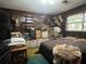 Large bedroom with wood walls, a king-size bed, and wall mounted trophies at 3800 Lavender Way, Casselberry, FL 32707