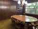 Dining room with wood-paneled walls, oval table, and wood chairs at 3800 Lavender Way, Casselberry, FL 32707