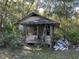 Small dilapidated house with overgrown vegetation at 3800 Lavender Way, Casselberry, FL 32707