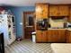 Retro kitchen features wood cabinets, vintage appliances, and tile floor at 3800 Lavender Way, Casselberry, FL 32707