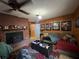 Living room with brick fireplace, wood paneling, and comfortable seating at 3800 Lavender Way, Casselberry, FL 32707